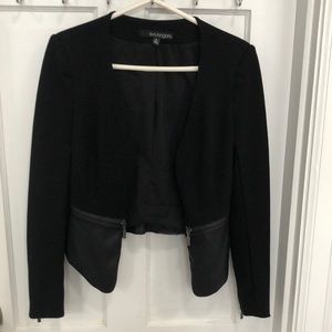 Eva Longoria black blazer with faux leather detail, zippered pockets.